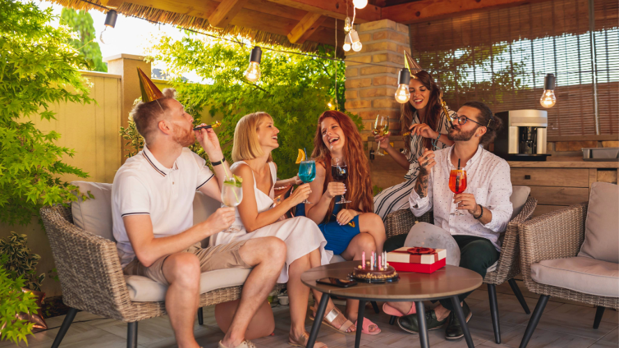Friends sitting in a patio enjoying drinks together.